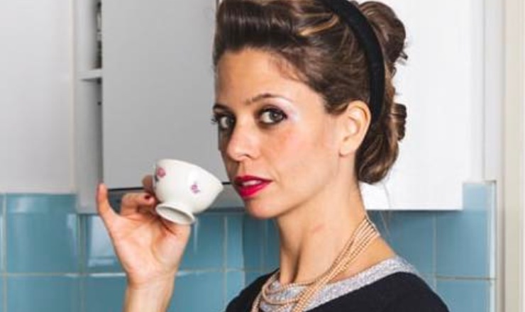 Donna che beve il caffè con il mignolo alzato